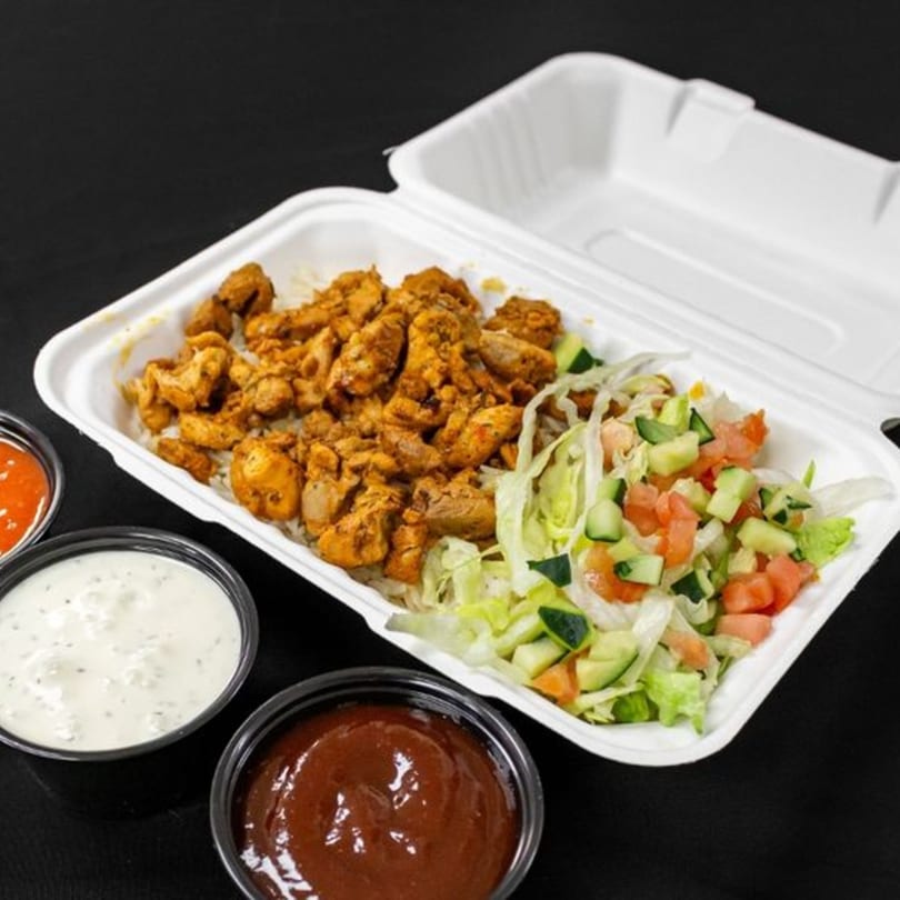Mother & Daughter Kitchen's fast-food chicken and rice platter with salad and three sauces.